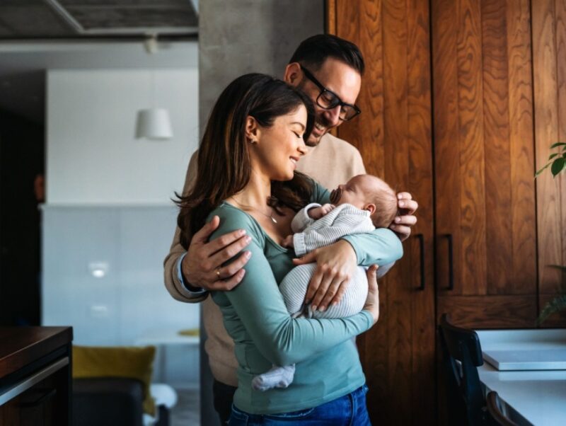 Two parents hold their baby