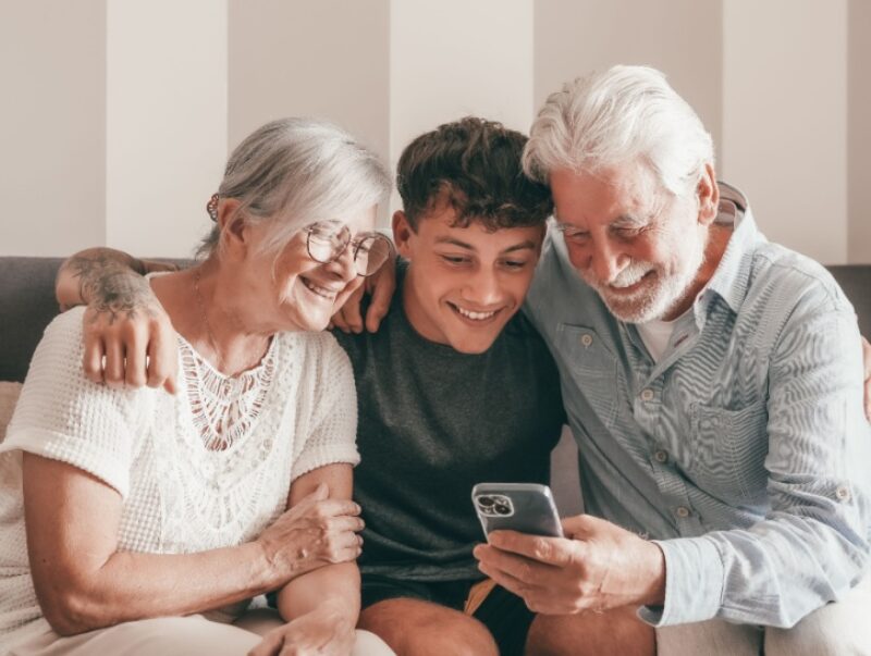 An older couple sit with their grandson