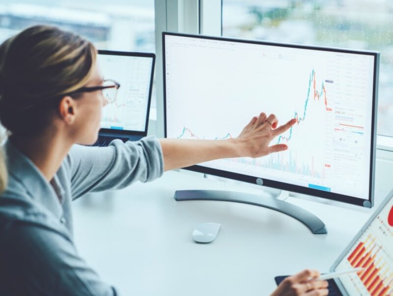 A woman looking at graphs on her computer