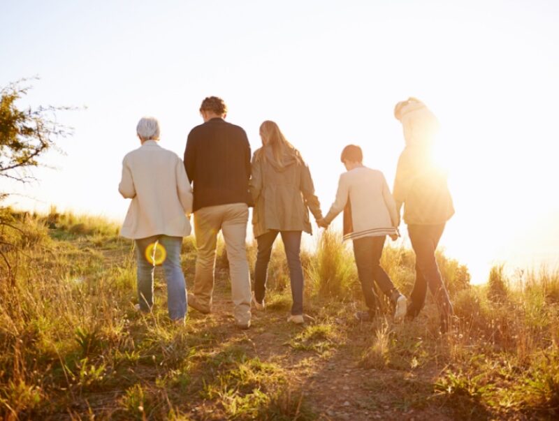 A large family go for a walk together outdoors