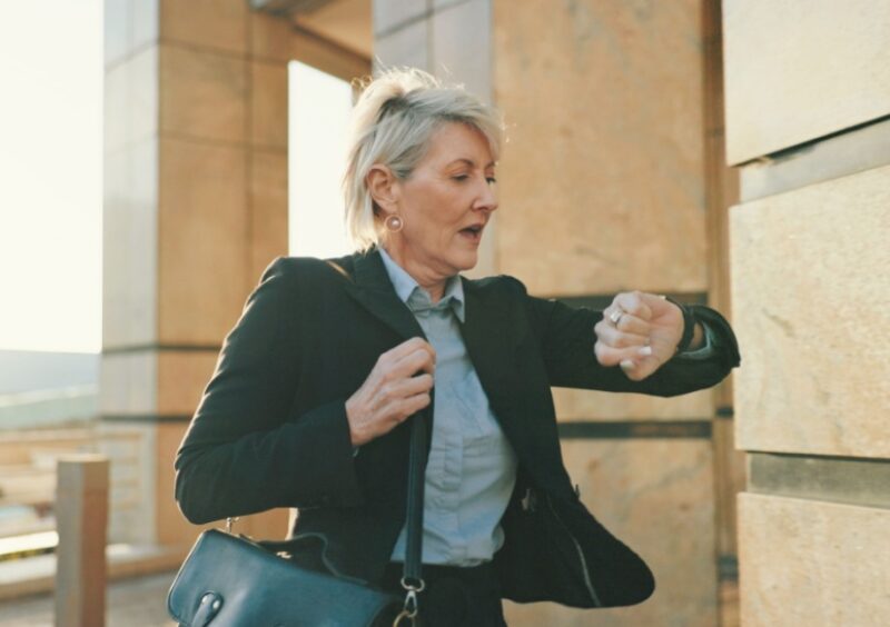 A rushed woman checking her watch