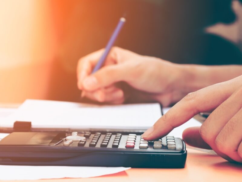 A close-up of a person using a calculator