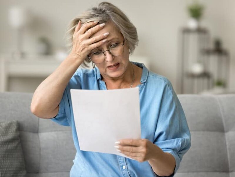 A shocked woman reading a letter
