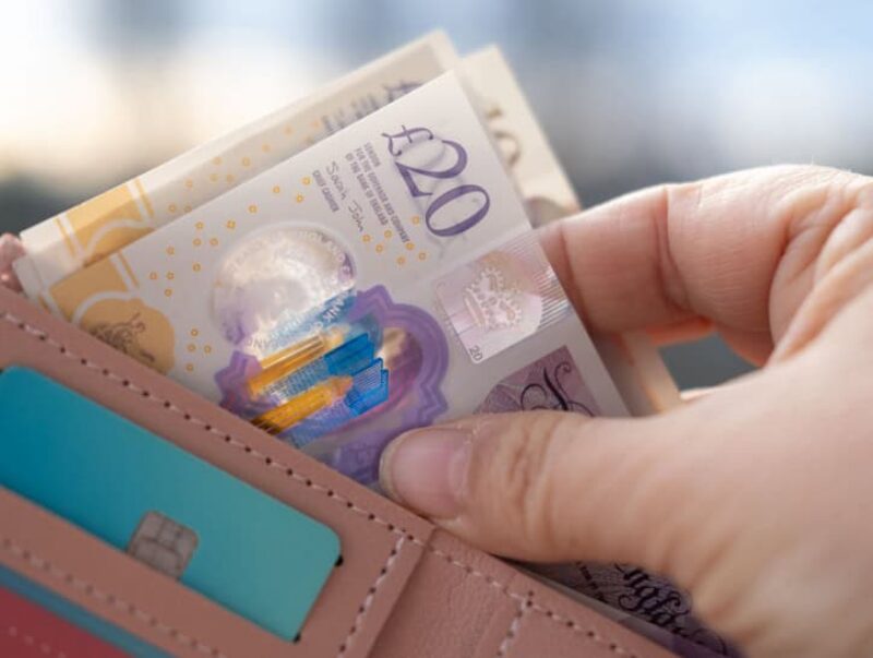 A person taking cash out of a wallet