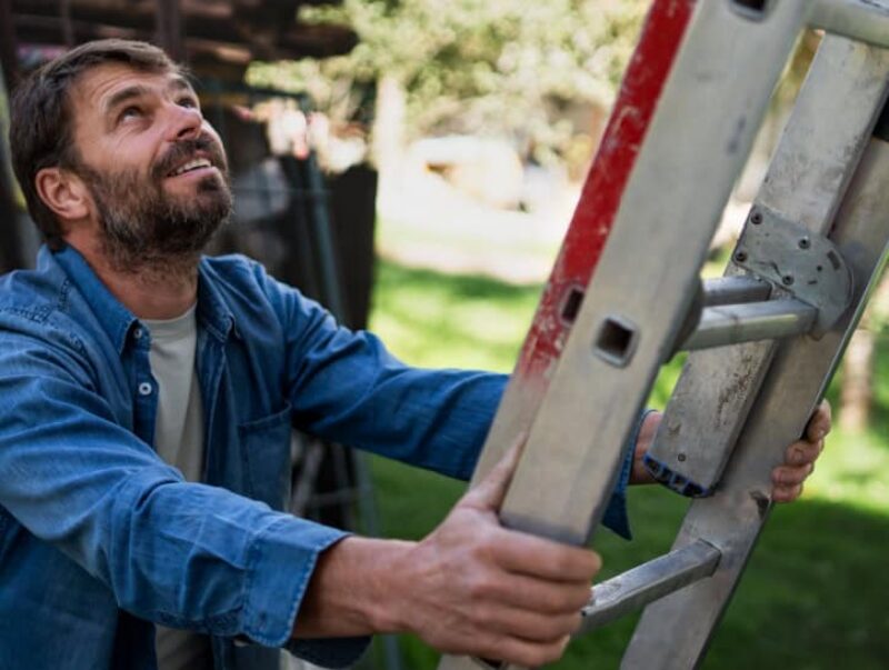 A man about to climb a ladder.