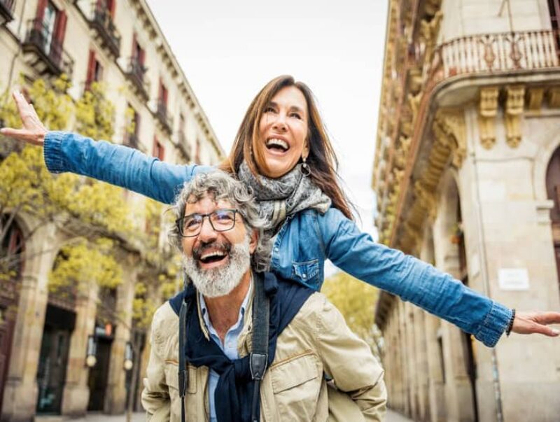 Happy older couple walking in city