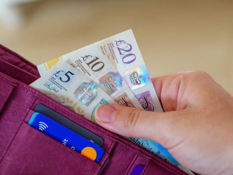 A person taking cash out of a wallet